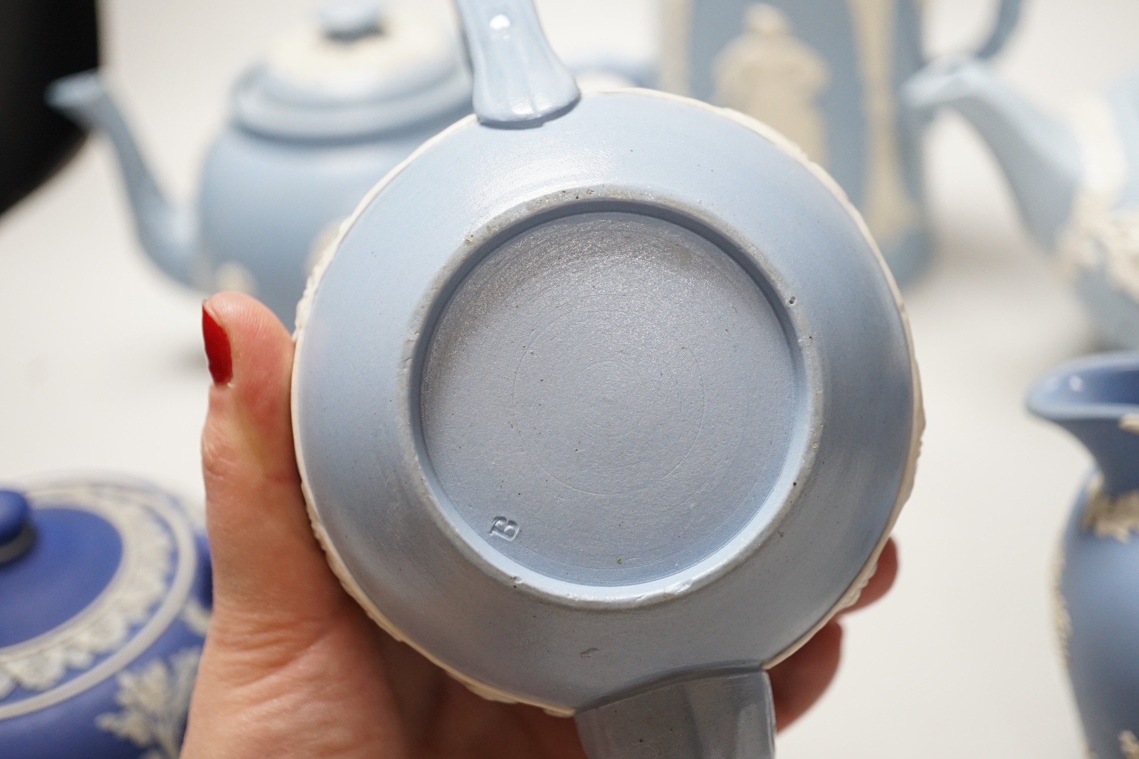 A group of Wedgwood and Wedgwood-style jasperware teapots and jugs.